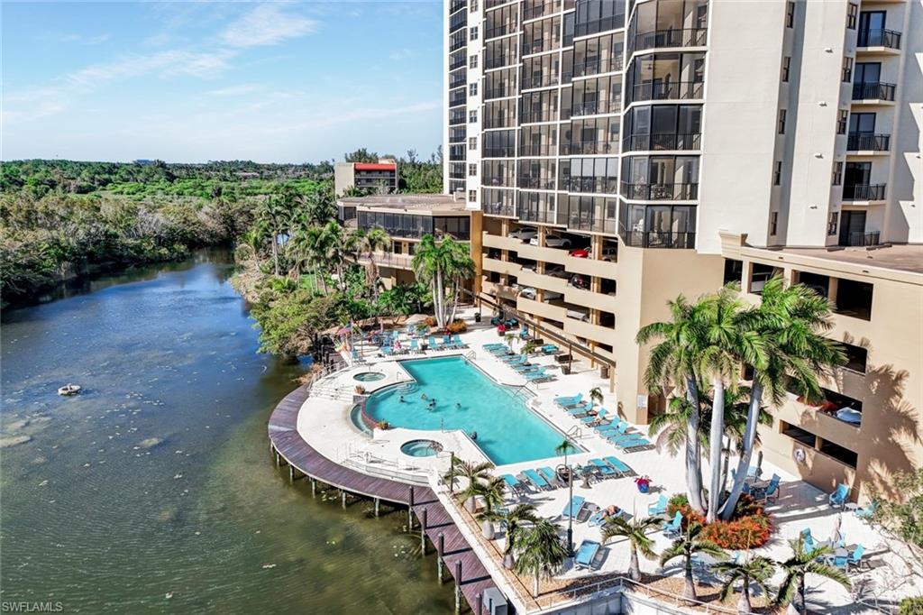 Community pool with a water view and a patio
