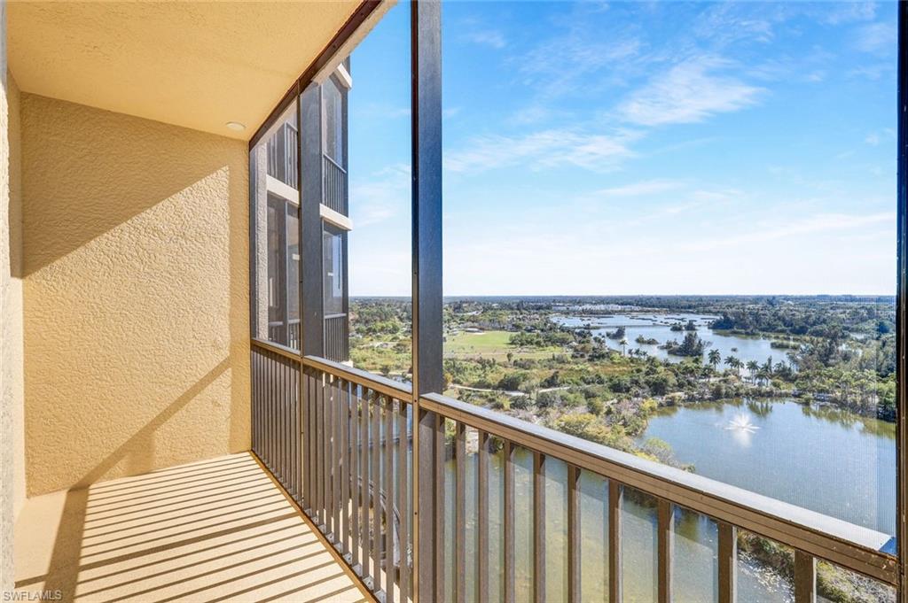 Balcony featuring a water view and a sunroom