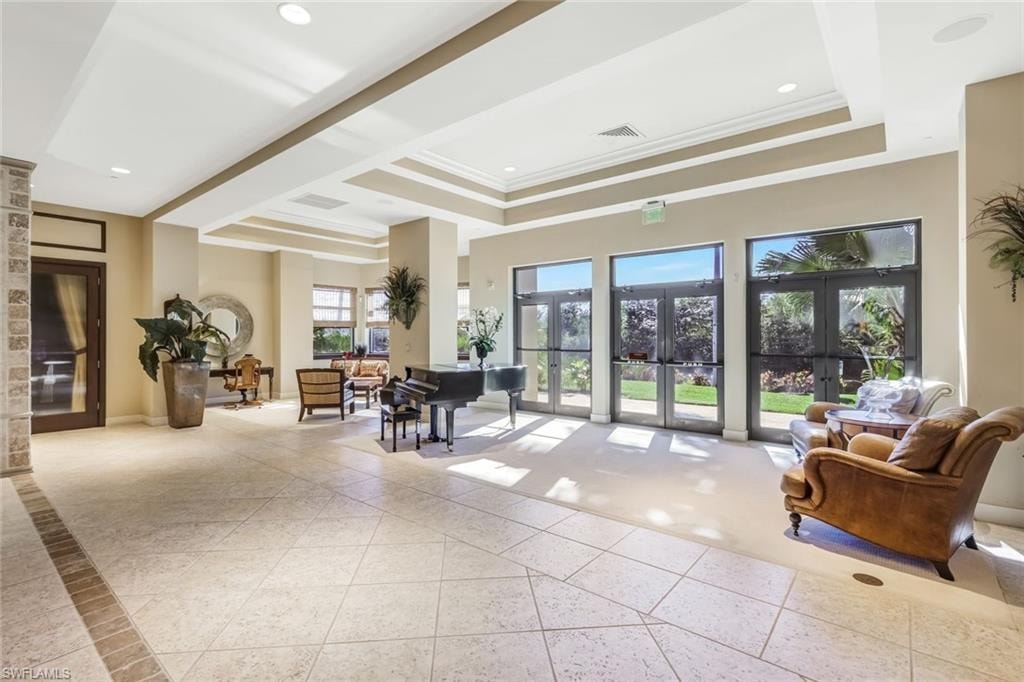 Common area featuring crown molding, a tray ceiling, and recessed lighting