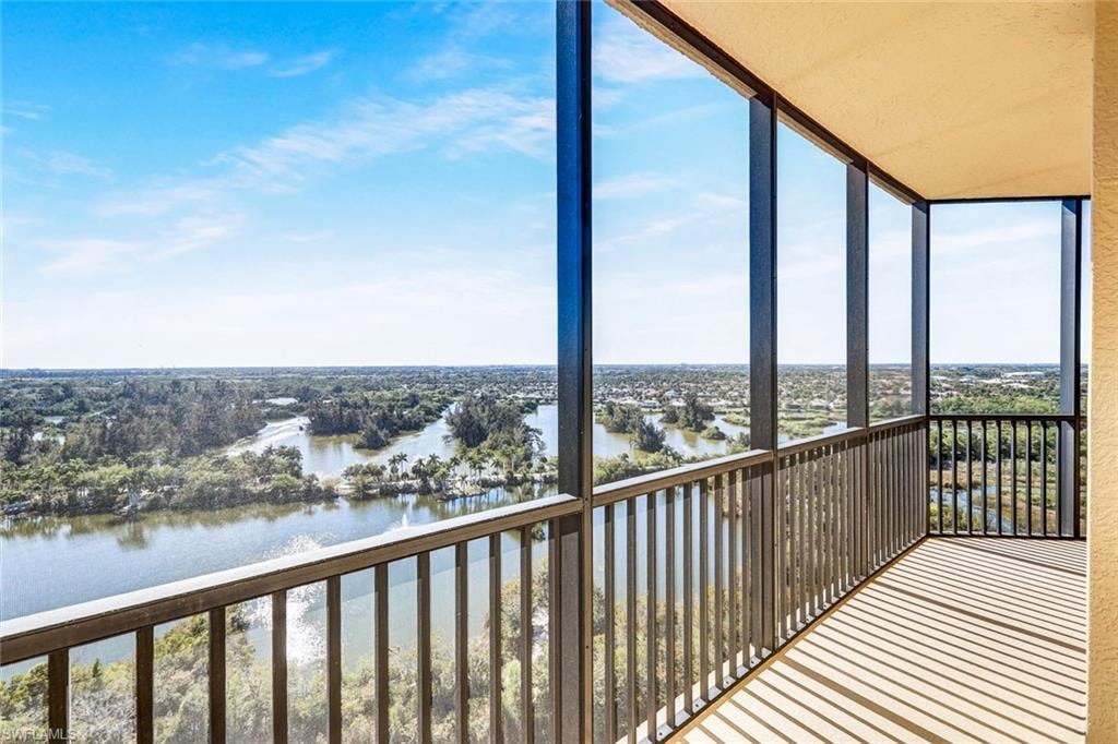 Balcony featuring a sunroom and a water view