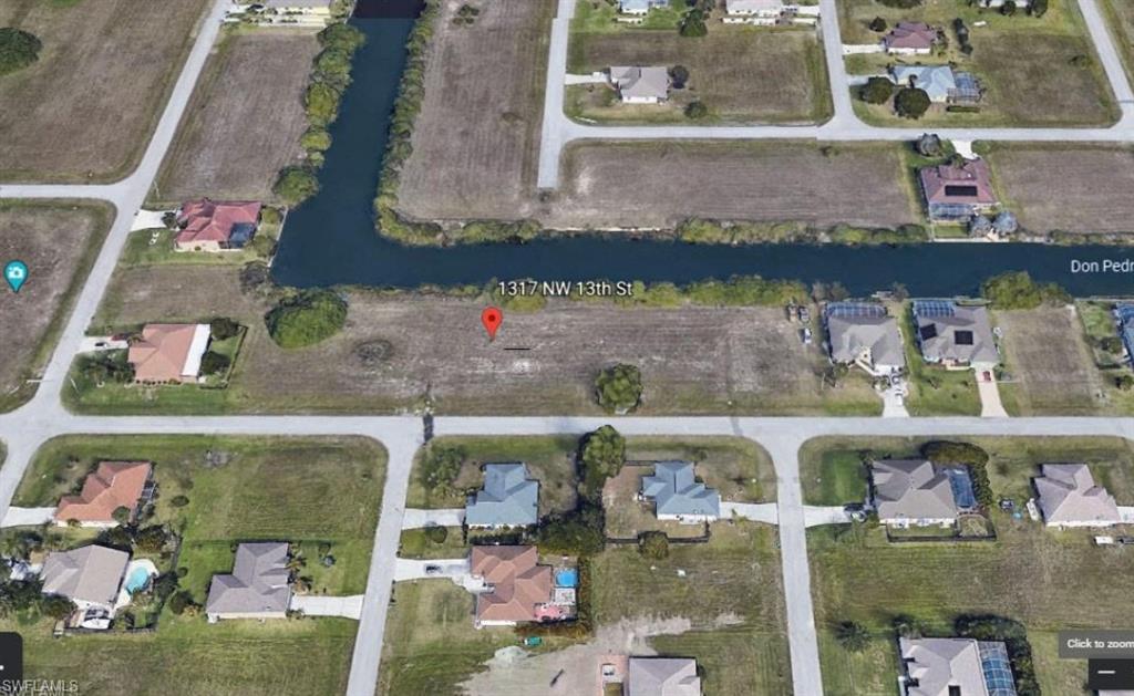 View of property location featuring nearby suburban area and a large body of water