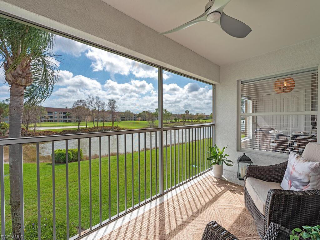 Sunroom featuring a textured wall, a water view, and carpet flooring