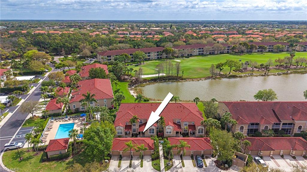 Drone / aerial view of a local golf course and a nearby body of water