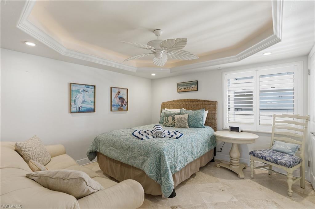 Guest Bedroom with tray ceiling and spacious enough for sitting couch.  Photo may be digitally enhanced.