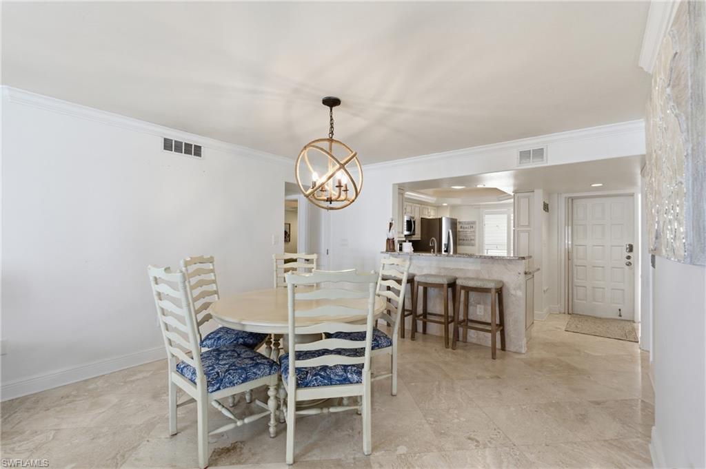 Dining table just off the kitchen with seating for five.  Photo Digitally Enhanced