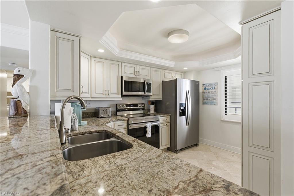 Beautiful granite counters, stainless steel appliances, and beautiful cabinetry.  Gorgeous tile through out the condo.  Photo Digitally Enhanced