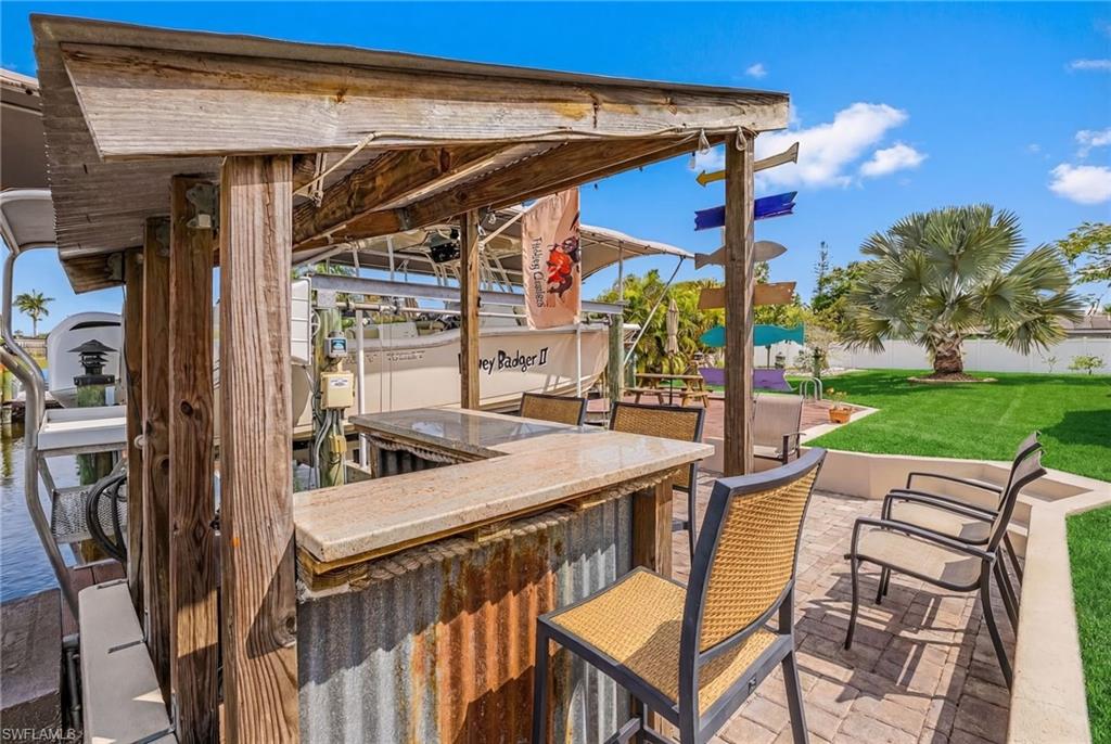 View of patio / terrace featuring boat lift and a dock