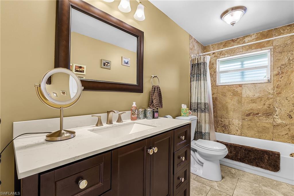 Full bath with vanity and shower / bathtub combination with curtain