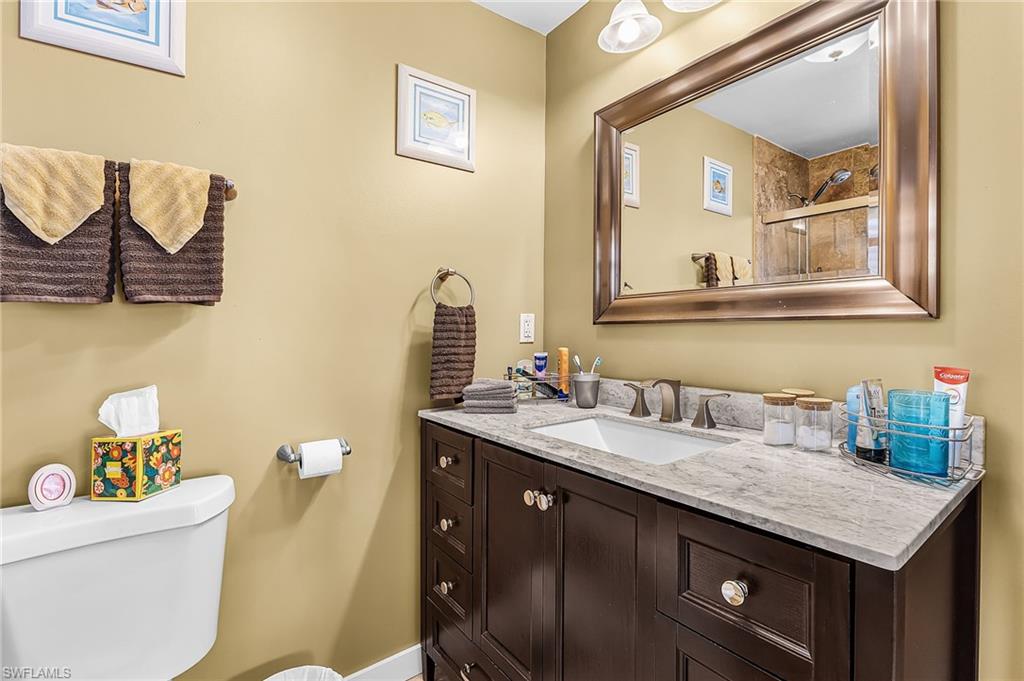 Bathroom with vanity and a tile shower