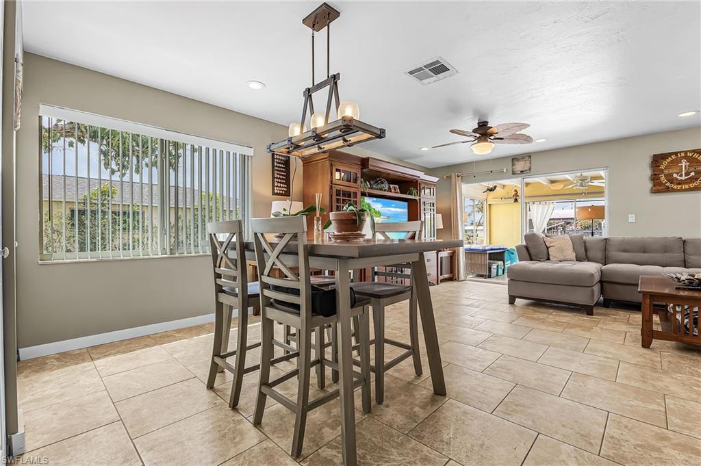 Dining space with a ceiling fan, light tile patterned floors, and recessed lighting