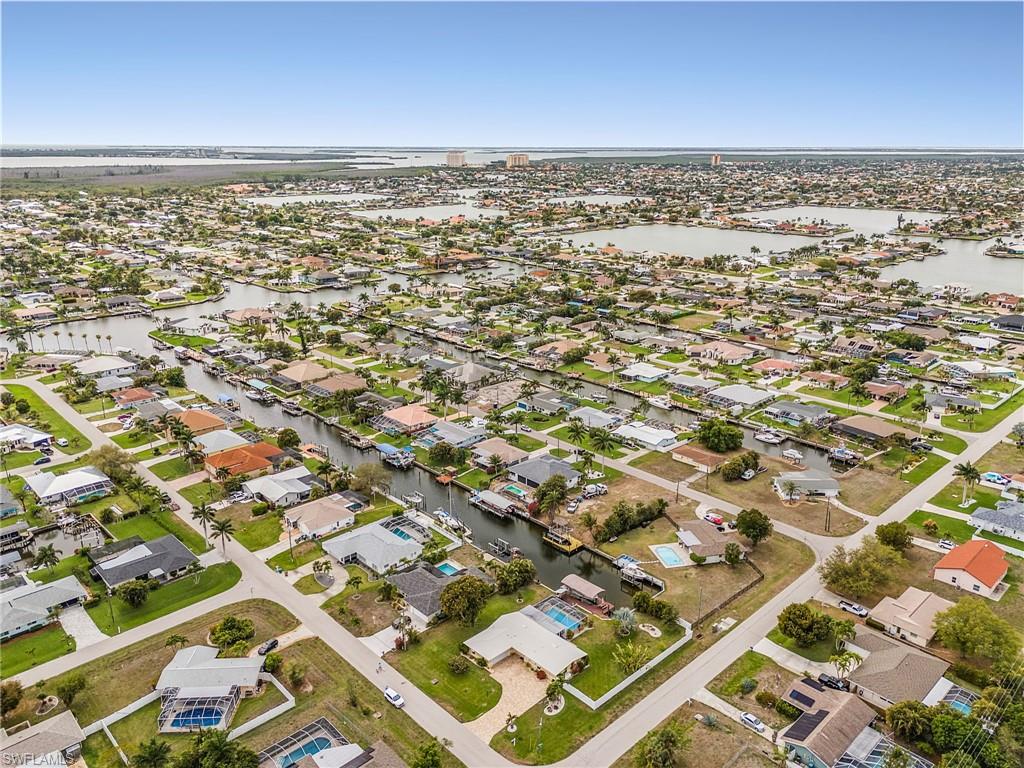 Aerial perspective of suburban area featuring a large body of water