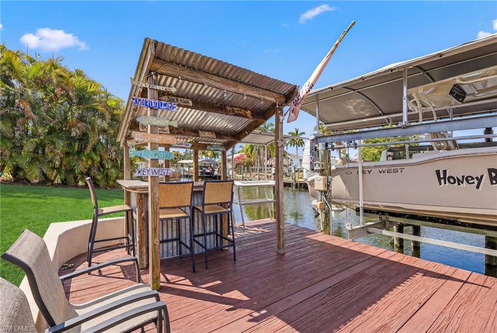 Dock with boat lift and a water view