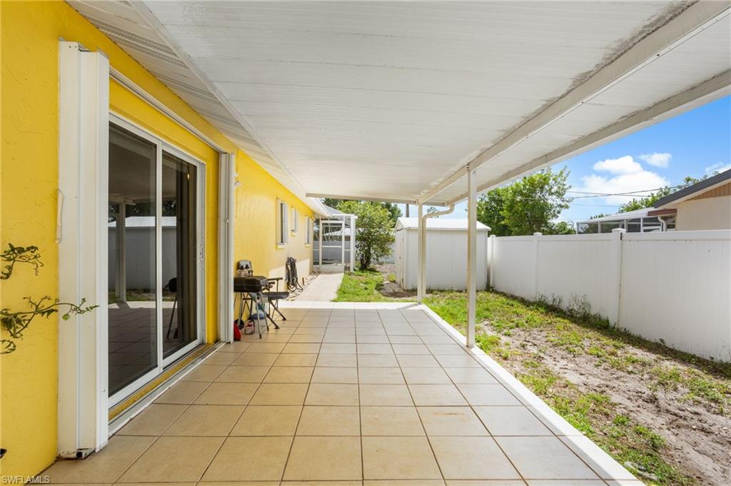 Fenced backyard with a patio
