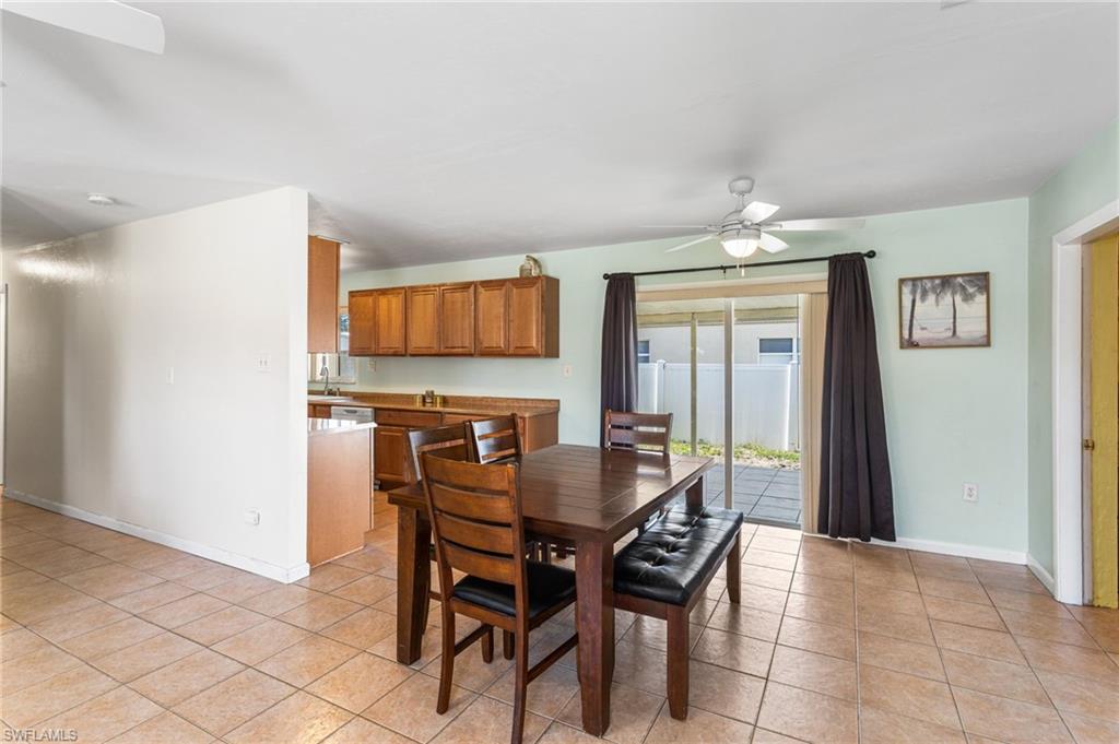 Dining room with ceiling fan and light tile patterned flooring