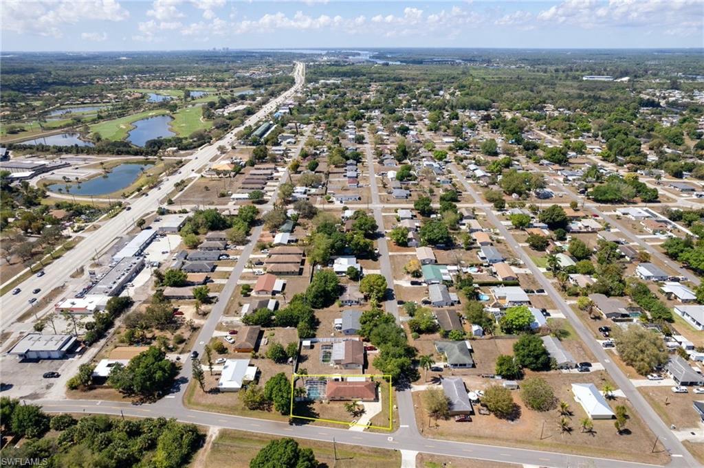 Aerial perspective of suburban area featuring a large body of water