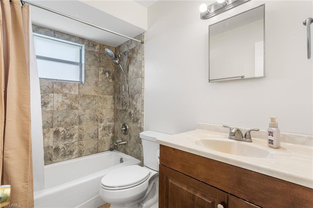 Full bathroom featuring vanity and shower / bath combination with curtain