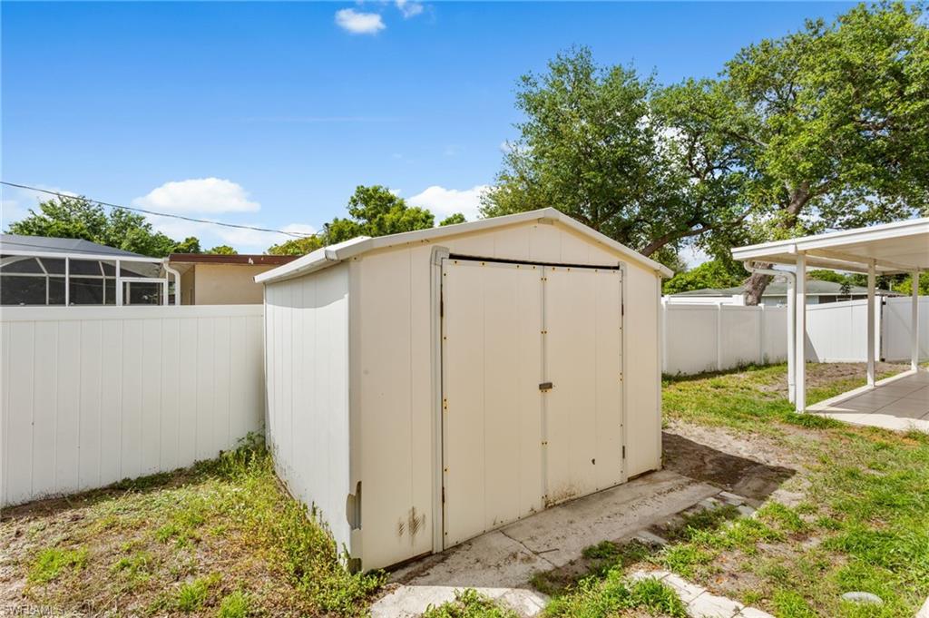 View of shed featuring a fenced backyard