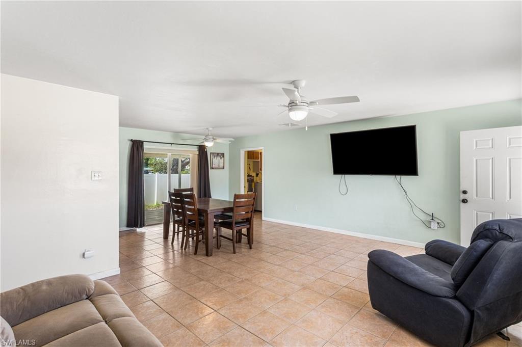 Living area with light tile patterned floors and a ceiling fan