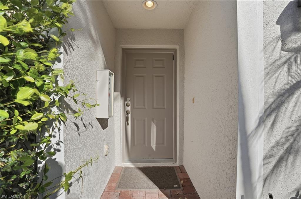 Entrance to property featuring stucco siding