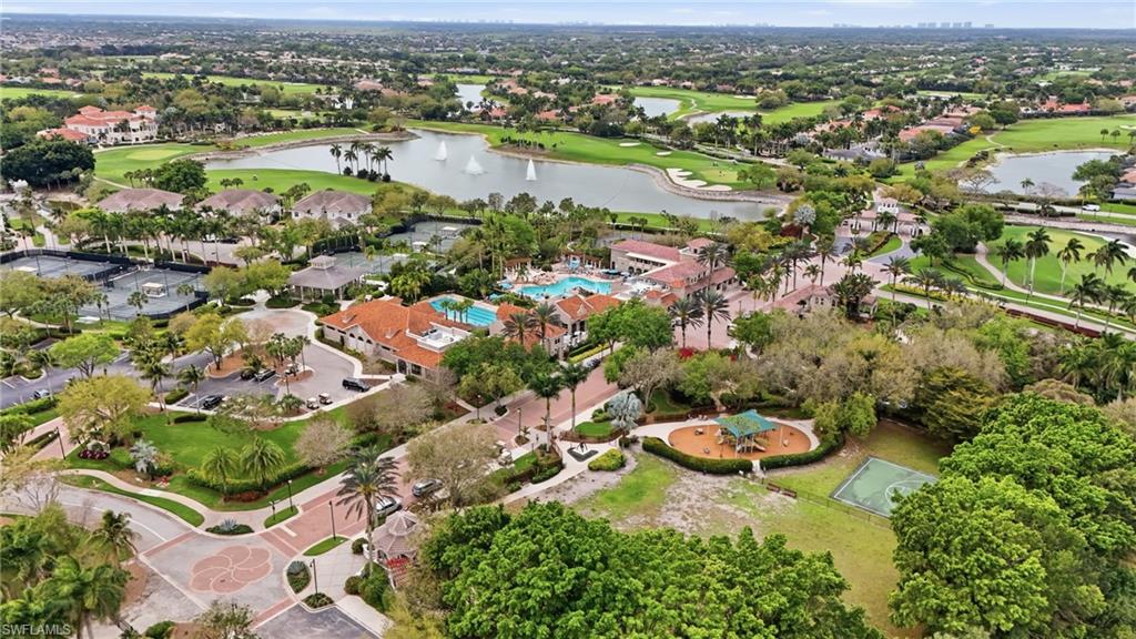 Aerial perspective of suburban area with a local golf course and a large body of water