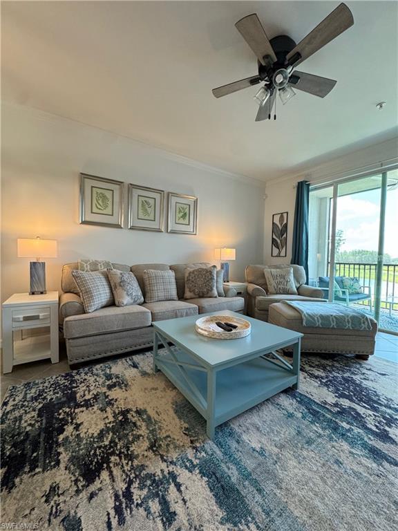 Living room featuring ceiling fan and crown molding