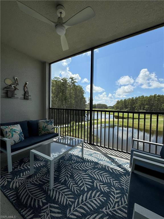 Sunroom featuring a water view and ceiling fan