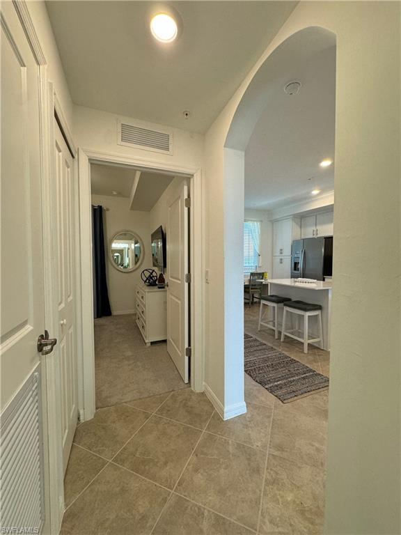 Hall with light tile patterned floors