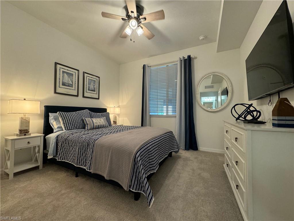 Carpeted bedroom with ceiling fan