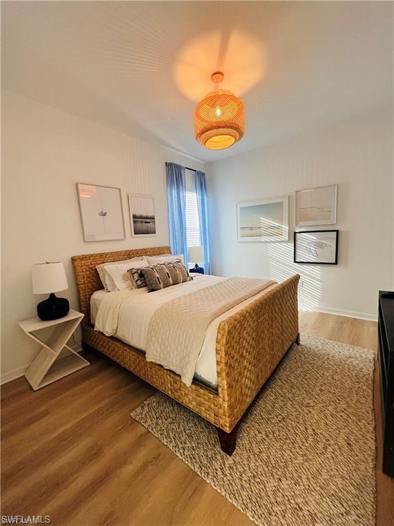 Bedroom with hardwood / wood-style flooring