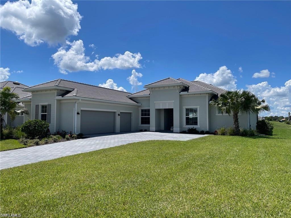 View of front of home featuring a garage and a front lawn