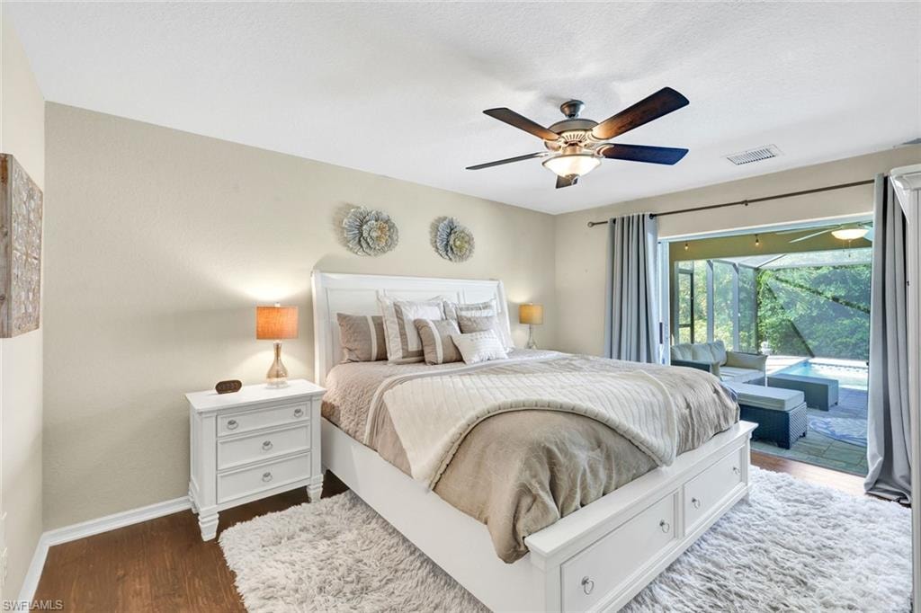 Bedroom with access to outside, wood finished floors, and a ceiling fan