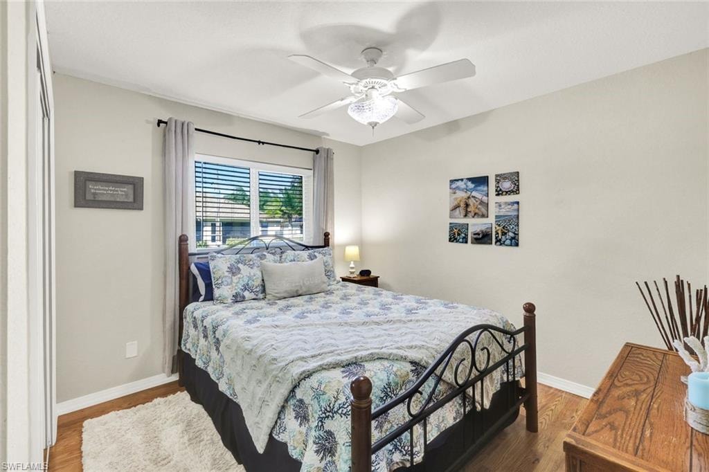 Bedroom with ceiling fan and wood finished floors