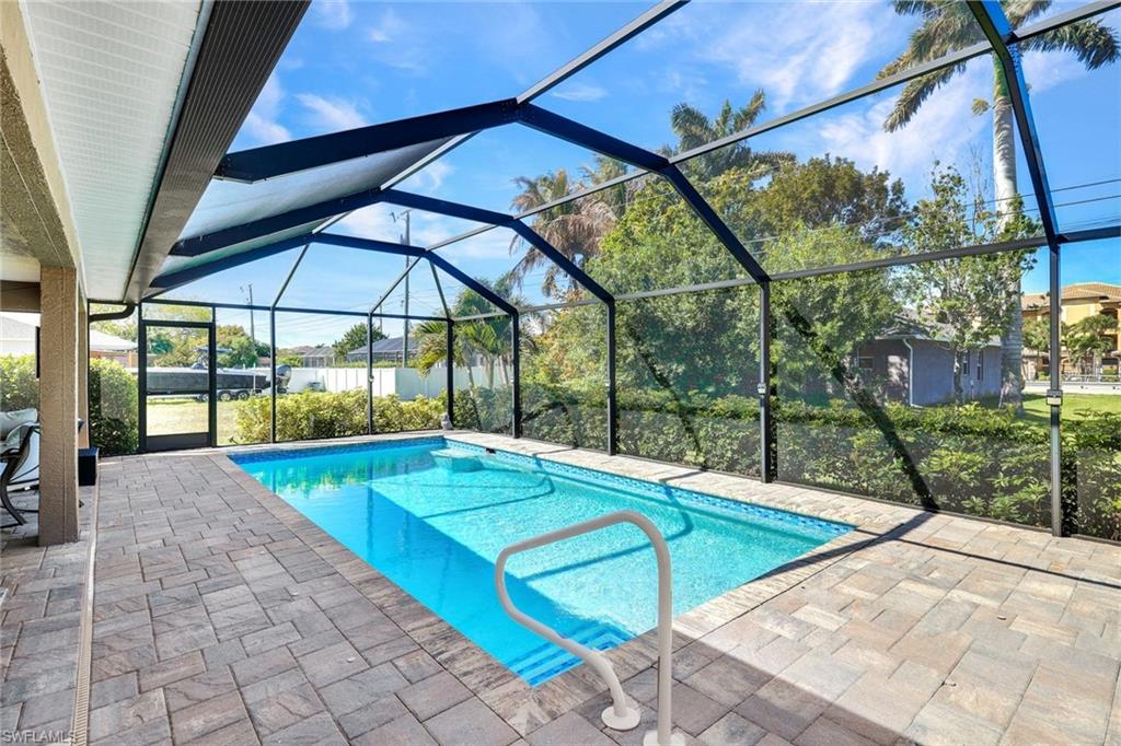 Swimming pool with a sunroom, a lanai, and a patio