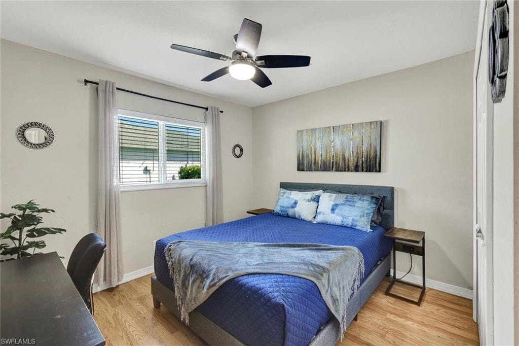 Bedroom with light wood-type flooring and ceiling fan