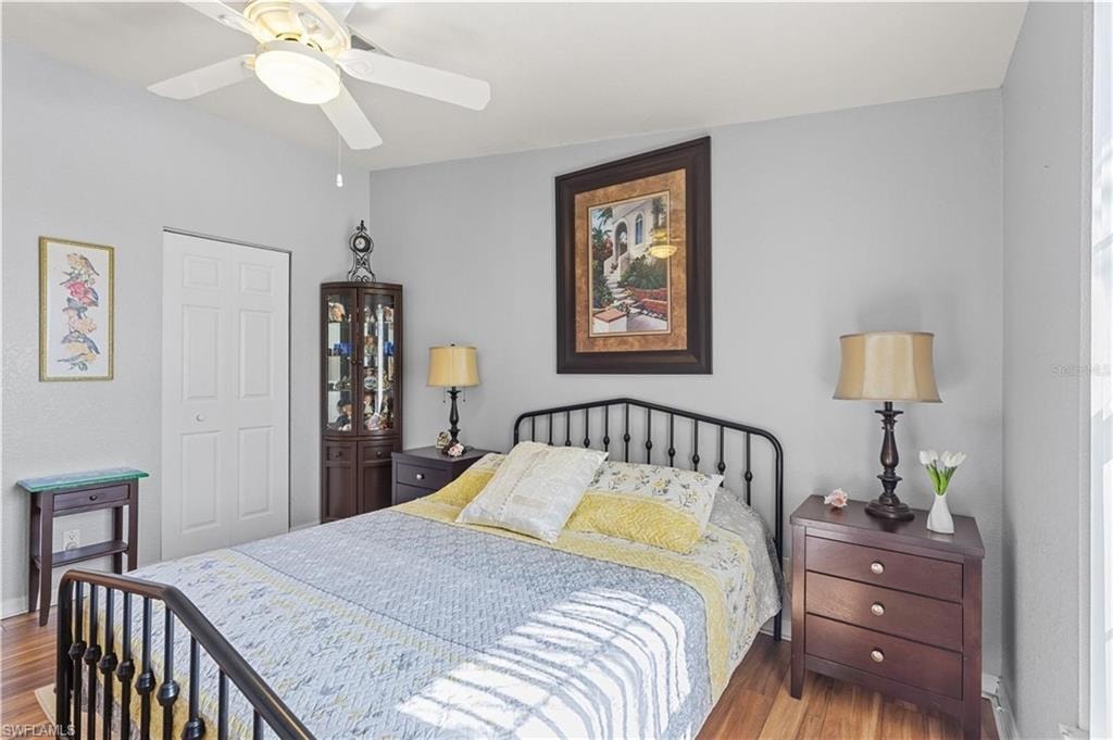 Bedroom with a closet, a ceiling fan, and wood finished floors