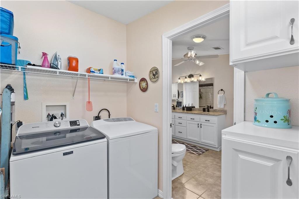 Laundry area featuring ceiling fan and washing machine and clothes dryer