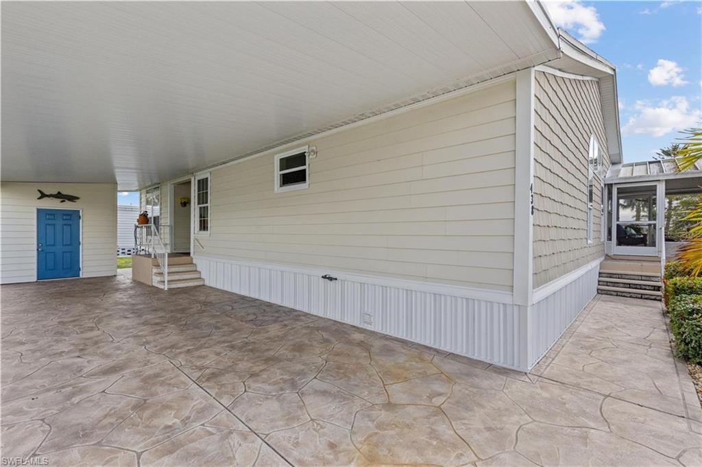 View of patio with entry steps and a carport