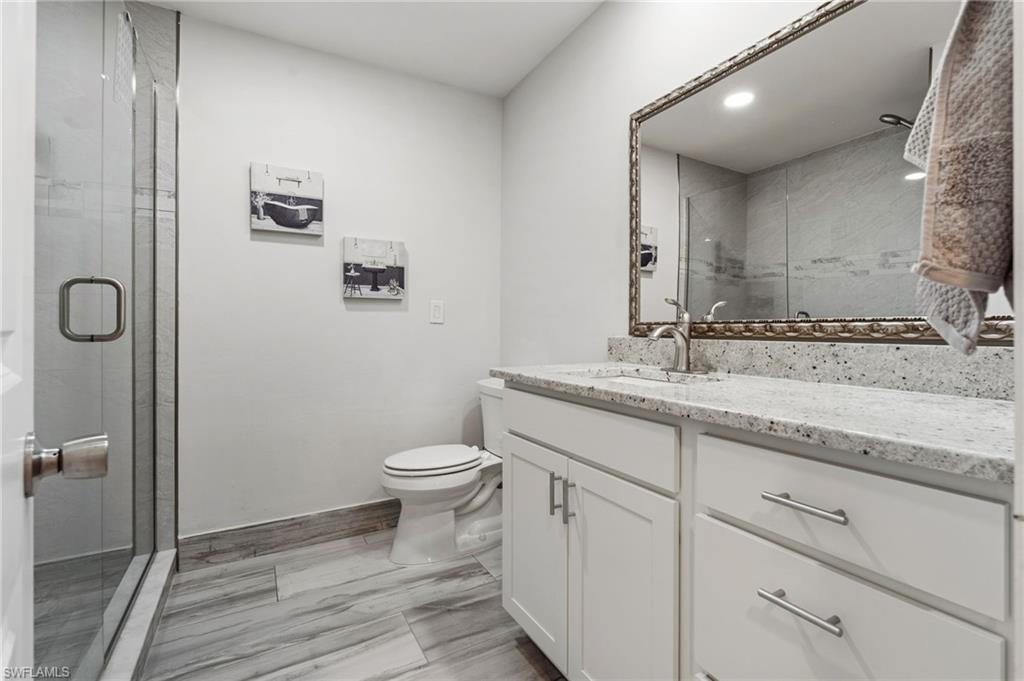 Full bathroom featuring vanity and a shower stall