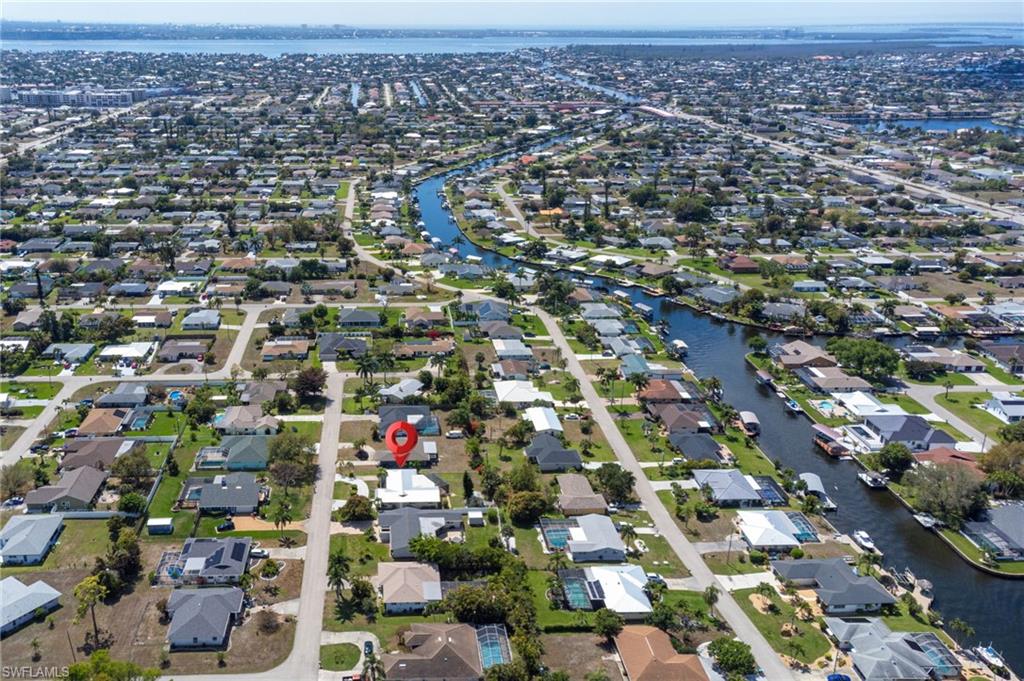 View of property location with a nearby body of water and nearby suburban area