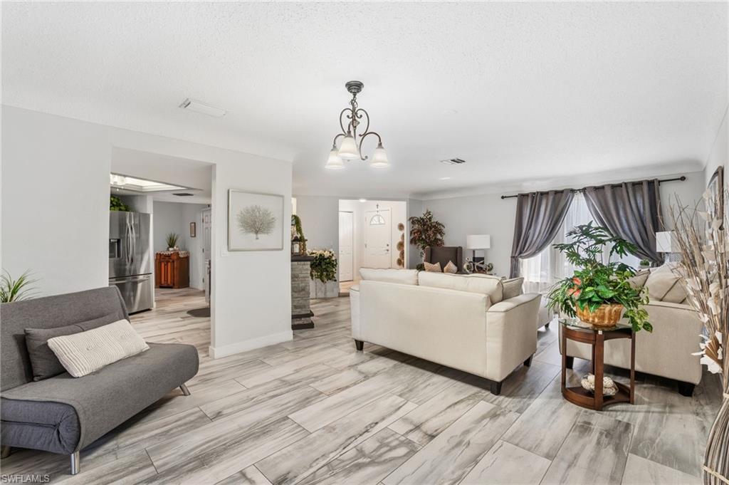 Living room with a chandelier and baseboards