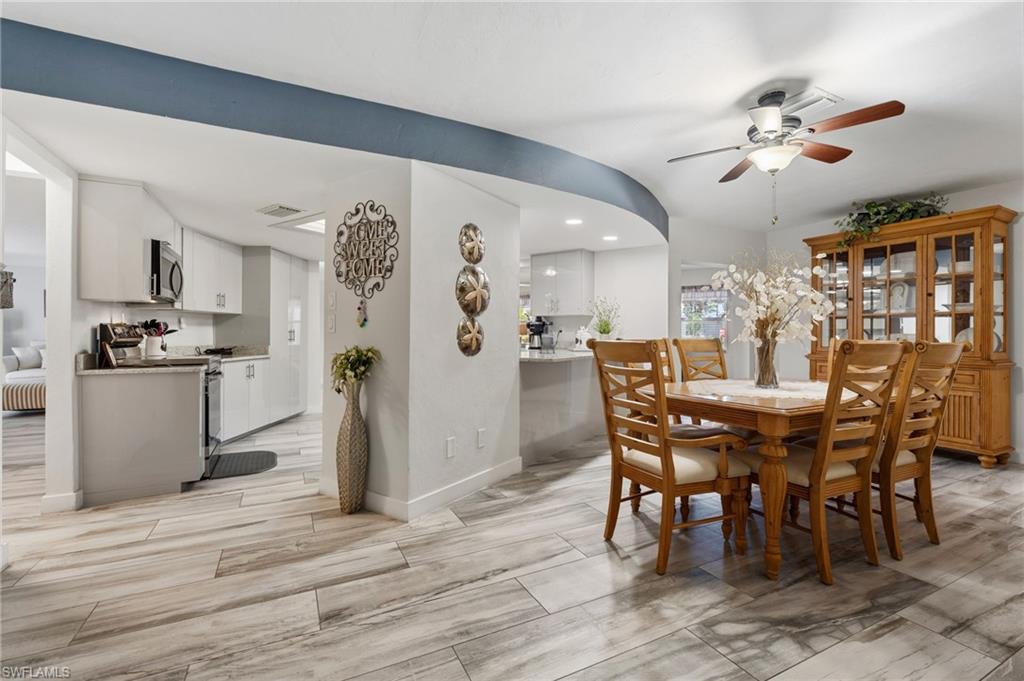 Dining area featuring ceiling fan, wood finish floors, and recessed lighting