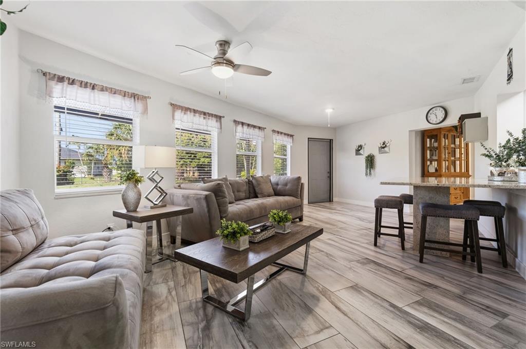 Living area featuring a ceiling fan and light wood finished floors