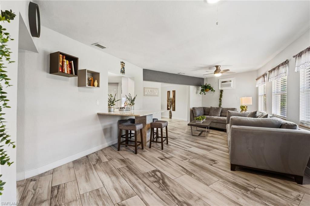 Living room with wood finish floors and ceiling fan