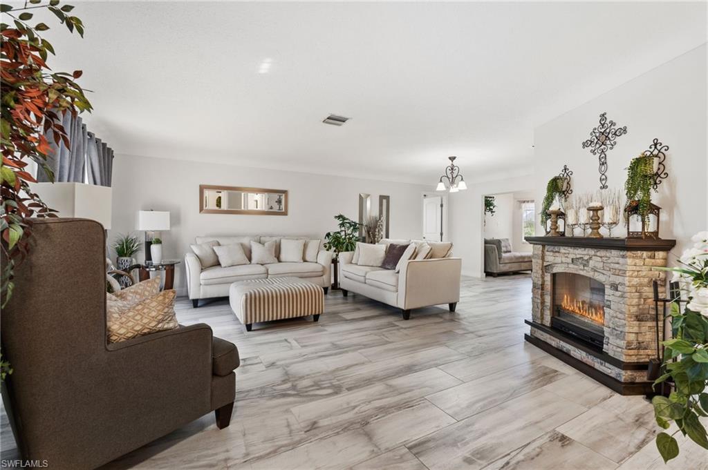 Living room featuring a fireplace and suspended lighting