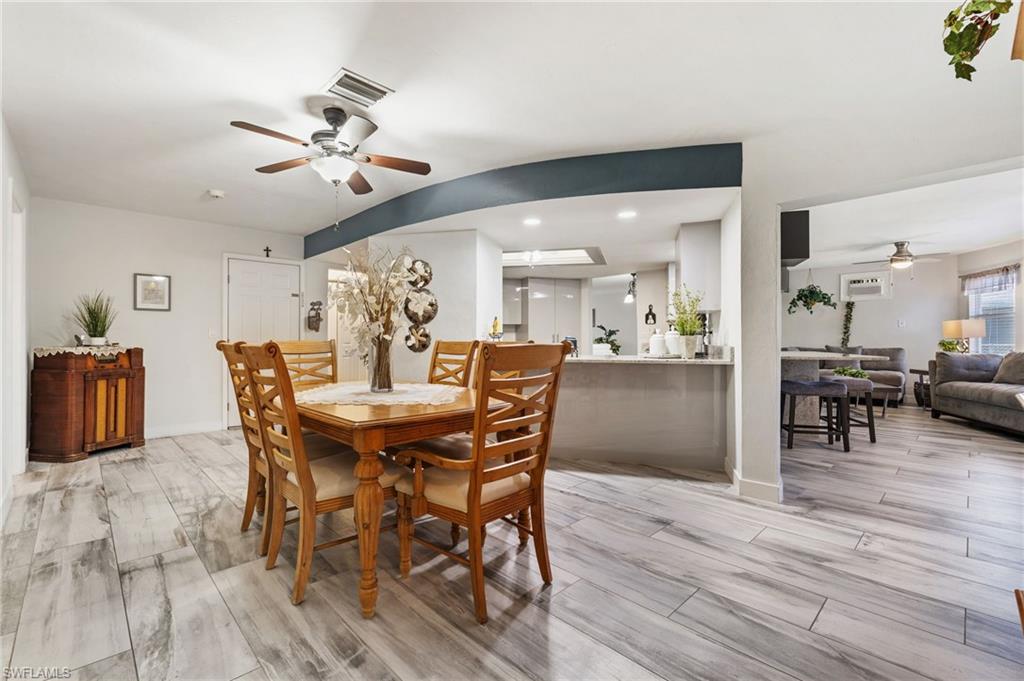Dining space with a ceiling fan, wood tiled floors, and recessed lighting
