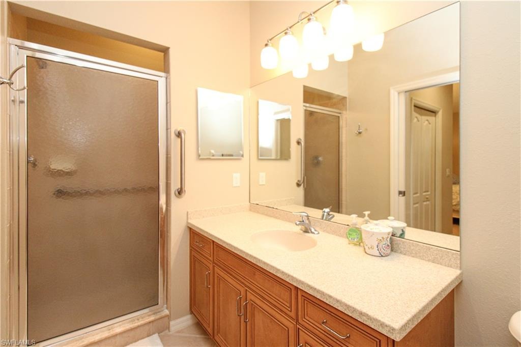 Bathroom featuring a stall shower and vanity