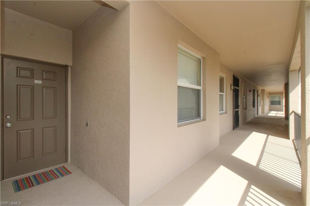 Entrance to property with stucco siding