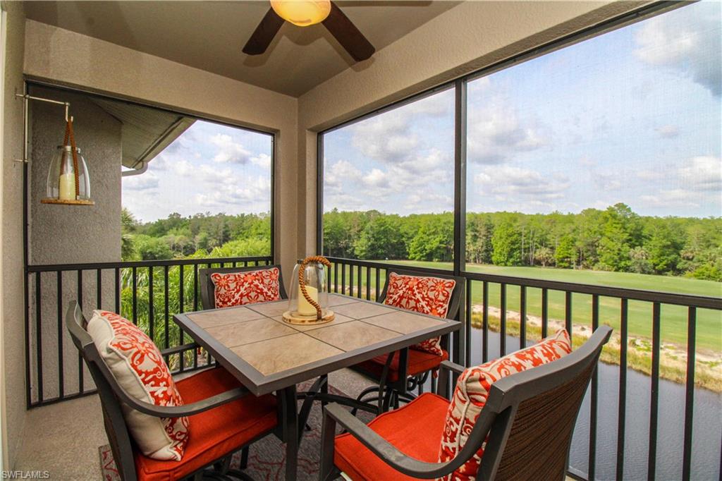 Sunroom with a wooded view, ceiling fan, and outdoor dining space