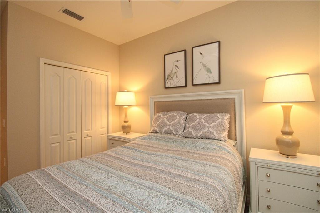 Bedroom with a closet, ceiling fan, and visible vents