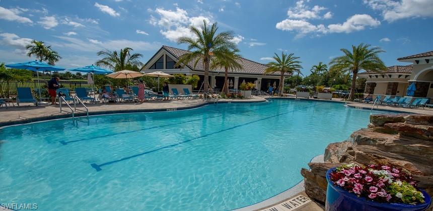 Community pool featuring a patio and fence